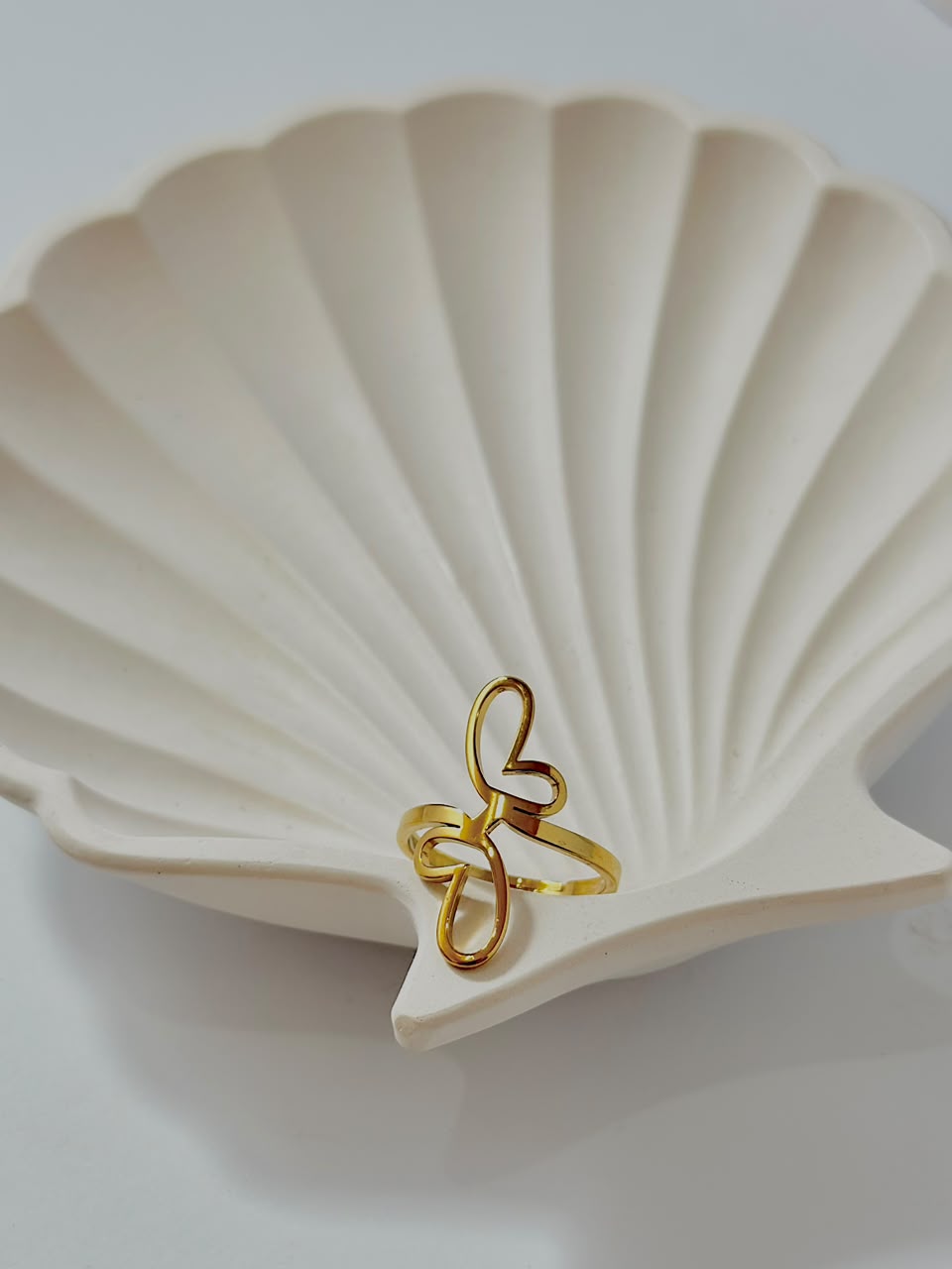 Silver abstract butterfly adjustable ring by Bloslily featuring a modern jewelry design with a delicate butterfly motif.