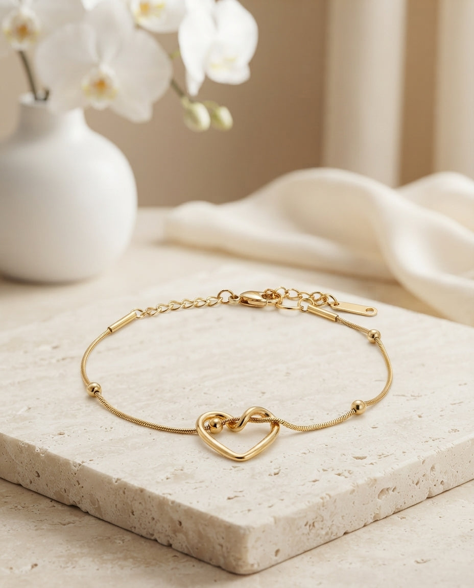 Silver intertwined heart bracelet with delicate heart outline design by Bloslily, showcasing elegant jewelry craftsmanship.