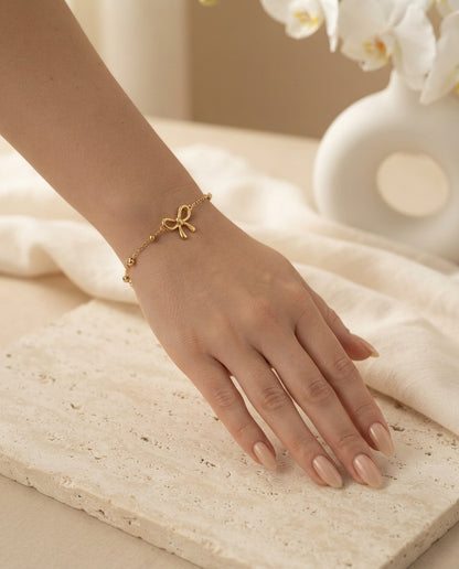 Dainty Bow Charm Bracelet by Bloslily featuring a delicate bow pendant on a fine jewelry chain.