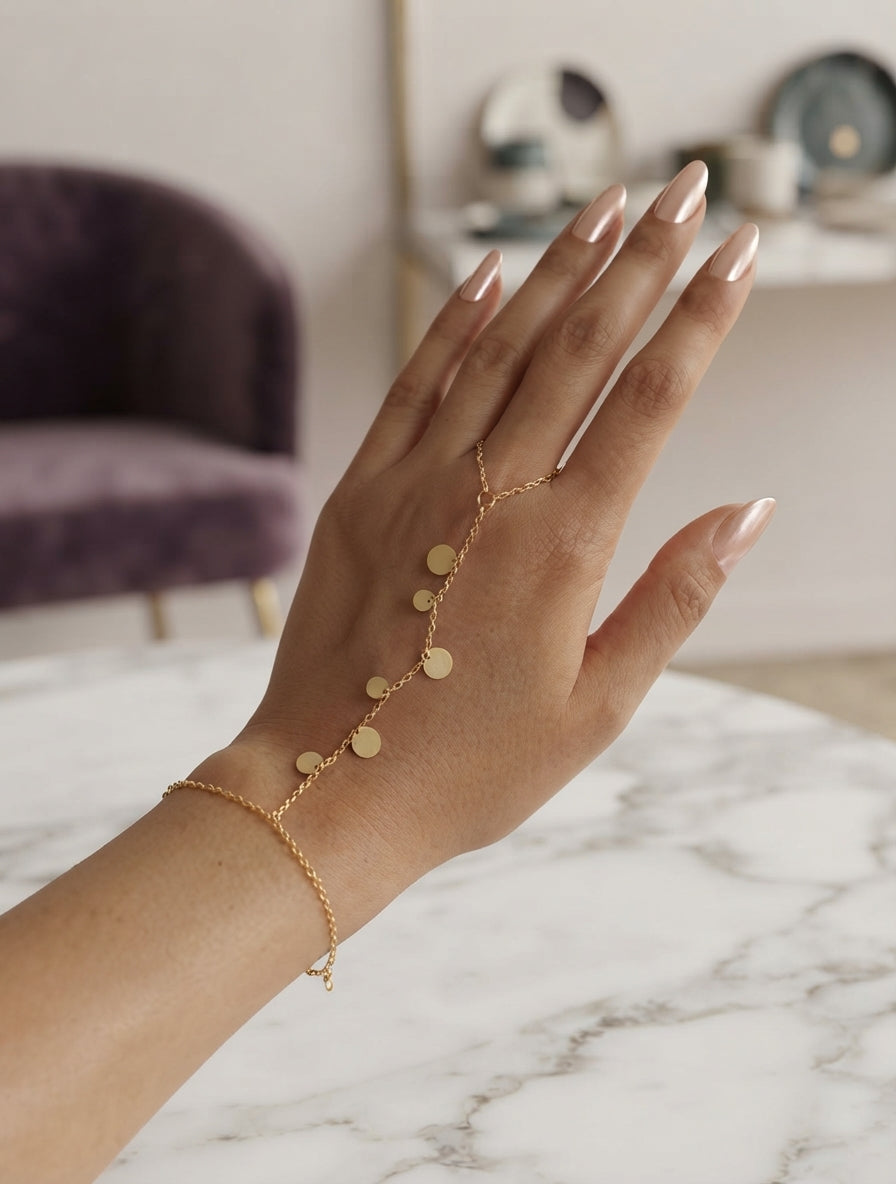 Gold coin charm hand chain jewelry by Bloslily featuring intricate coin and chain design on a delicate hand accessory.