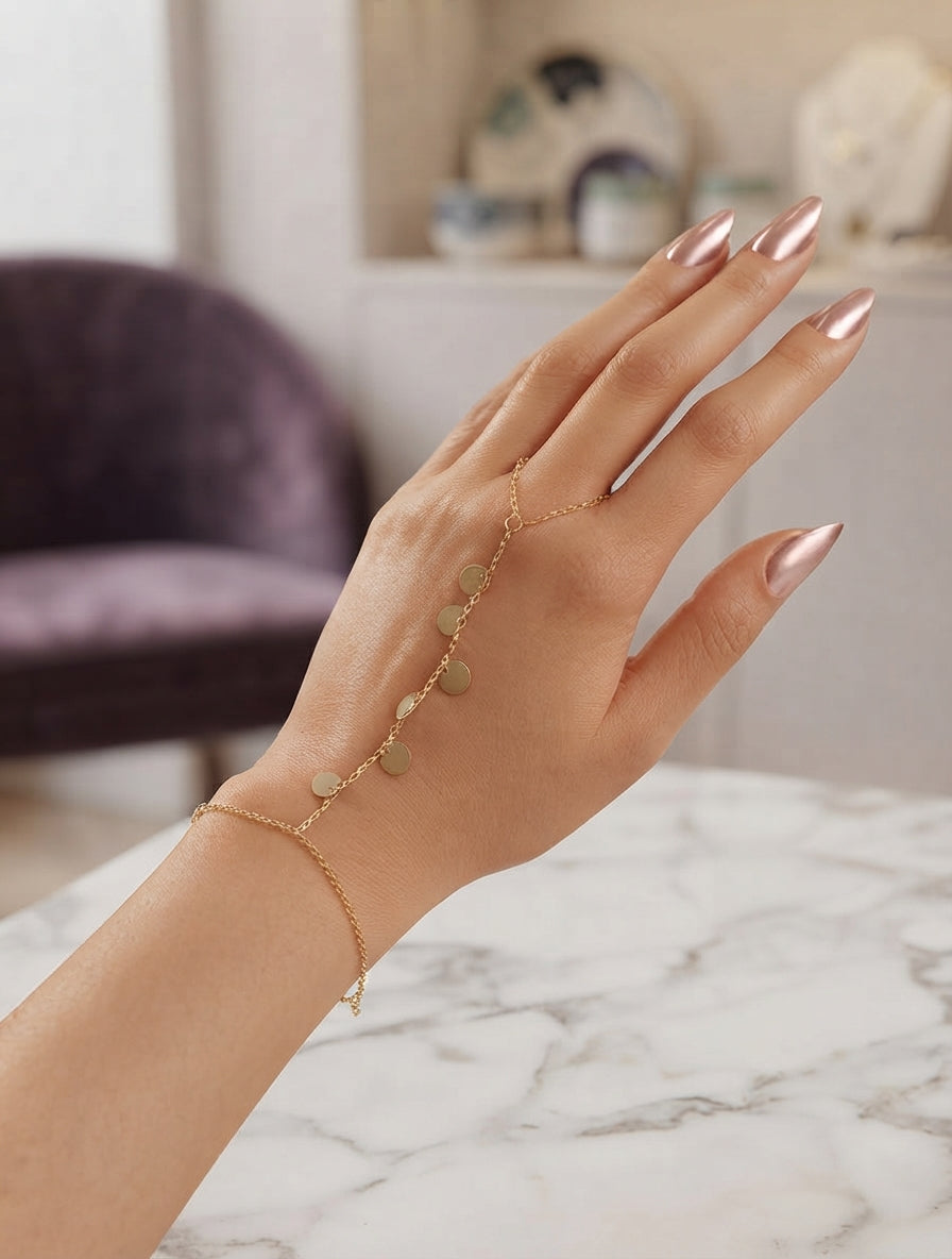Silver coin charm hand chain jewelry by Bloslily featuring a delicate chain and Gemini-themed coin charms on a neutral background.