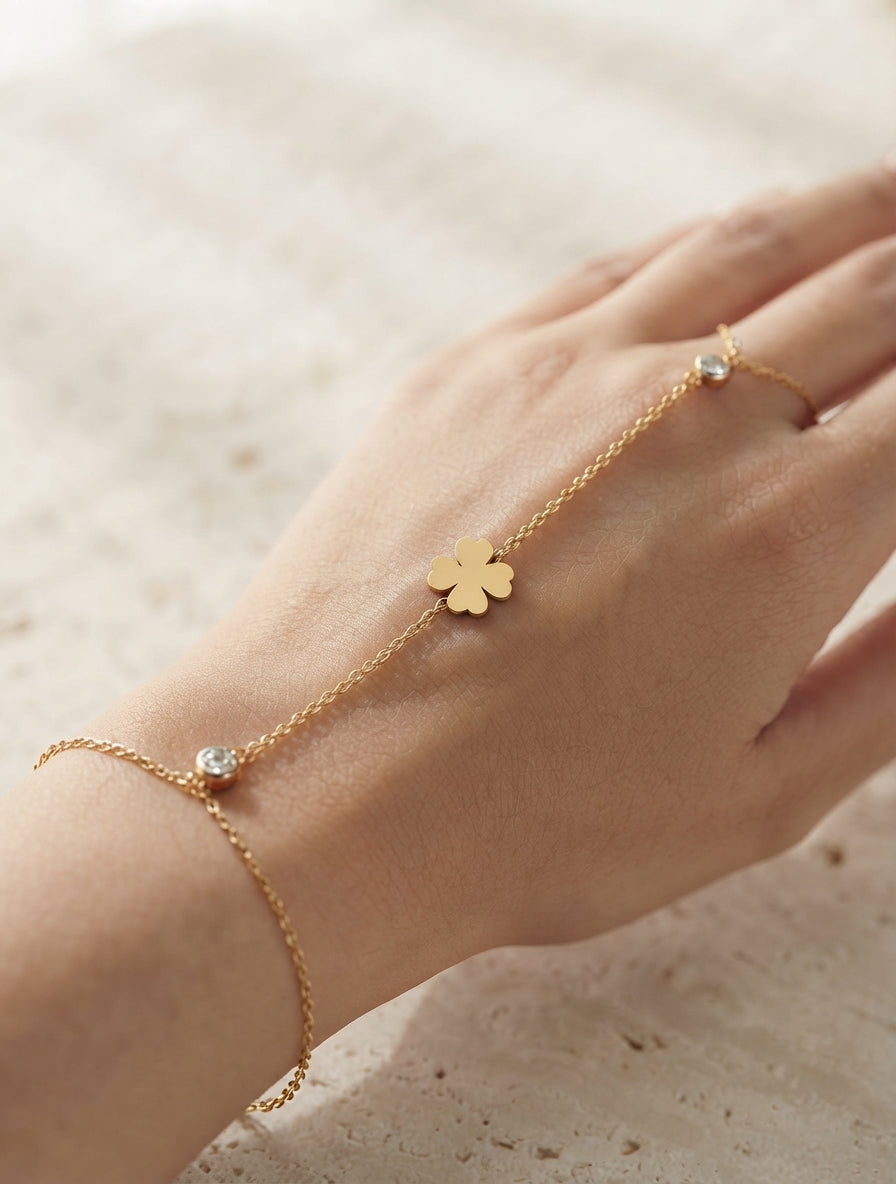 Dainty leaf and crystal hand chain jewelry by Bloslily, featuring delicate leaf design and sparkling crystals on a silver tone chain.