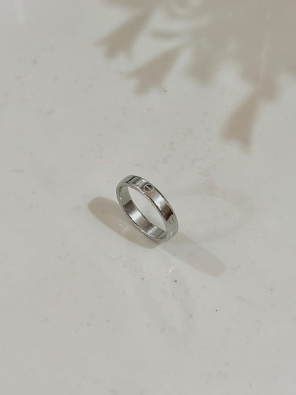 Silver Cartier Style Love Ring by Bloslily, close-up of the elegant jewelry piece with smooth, polished surface and engraved design.