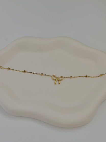 Bloslily dainty bow charm bracelet featuring a delicate bow pendant on a fine jewelry chain.