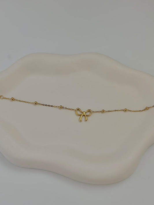 Bloslily dainty bow charm bracelet featuring a delicate bow pendant on a fine jewelry chain.