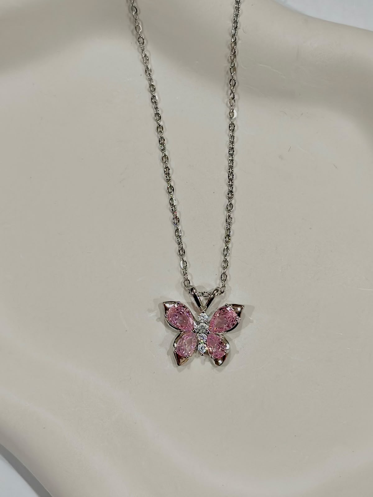 Silver crystal butterfly necklace by Bloslily featuring a sparkling butterfly pendant on a delicate chain.