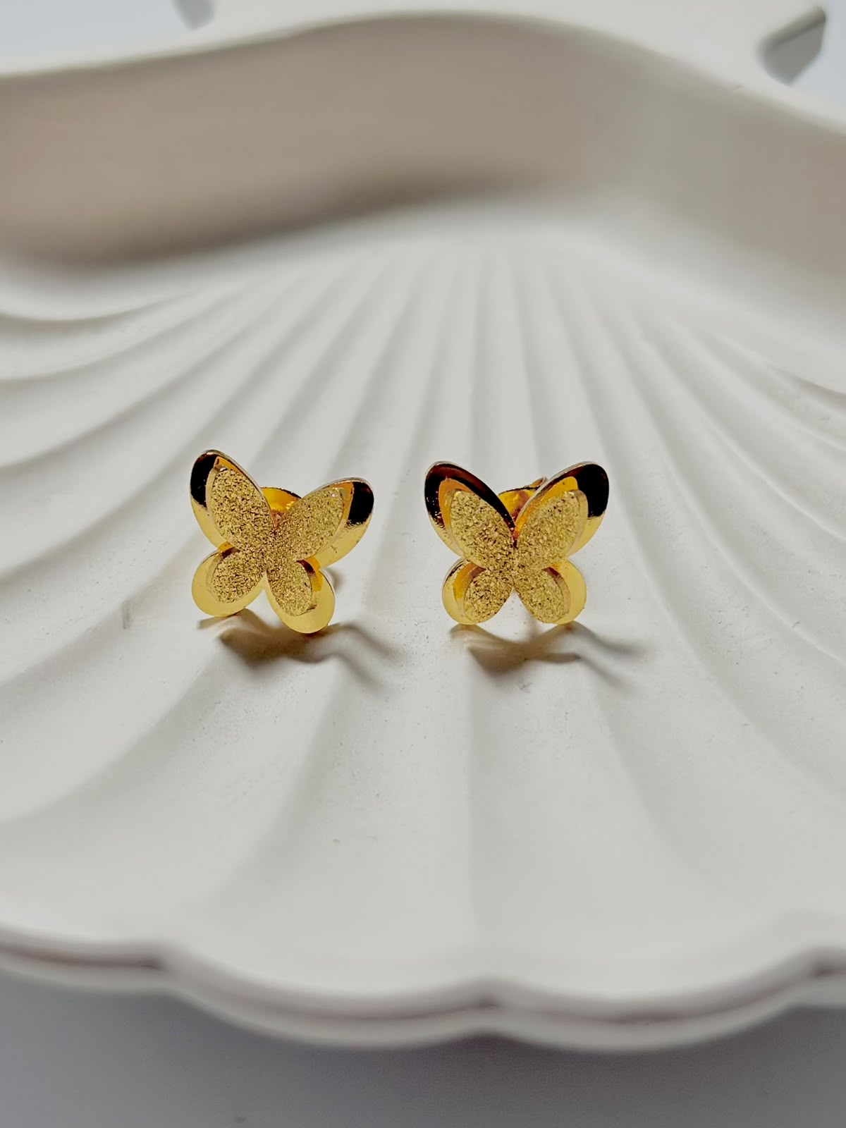 Textured frosted butterfly stud earrings from Bloslily, showcasing delicate butterfly design and matte finish in jewelry image.