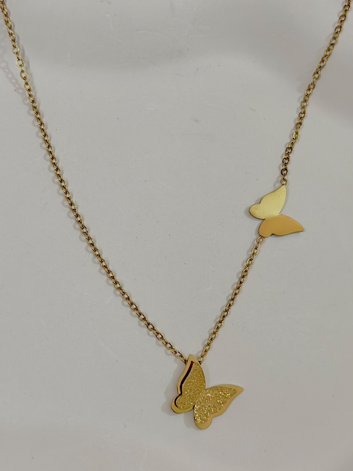 Bloslily dual butterfly frosted pendant necklace with two delicate butterfly charms on a fine chain, elegant jewelry accessory.