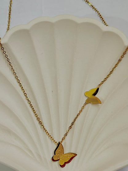 Frosted dual butterfly pendant necklace by Bloslily, featuring two delicate butterfly charms on a fine chain jewelry piece.