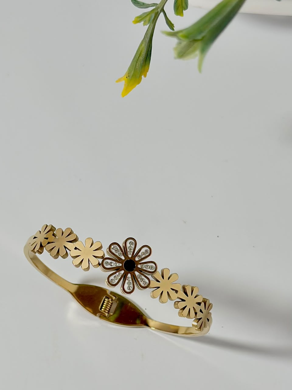 Bloslily Dainty Daisy Crystal Handcuff jewelry featuring a delicate flower design with sparkling crystals on a silver-tone bracelet.