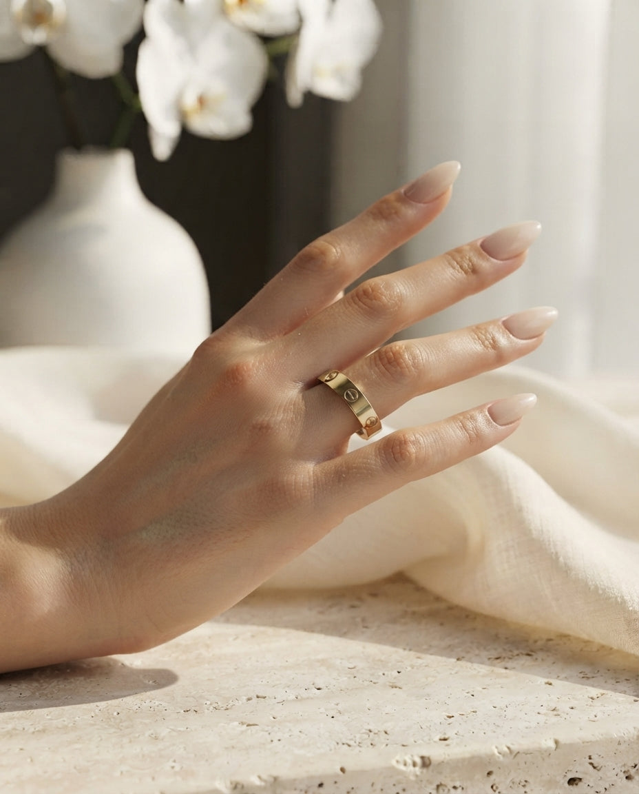 Golden Cartier Style Love Ring by Bloslily, showcasing a sleek gold and silver jewelry design with intricate detailing.