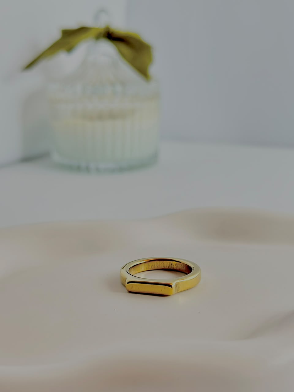 Gold flat top signet ring by Bloslily, showcasing a sleek, polished jewelry design with a flat, wide surface and smooth finish.