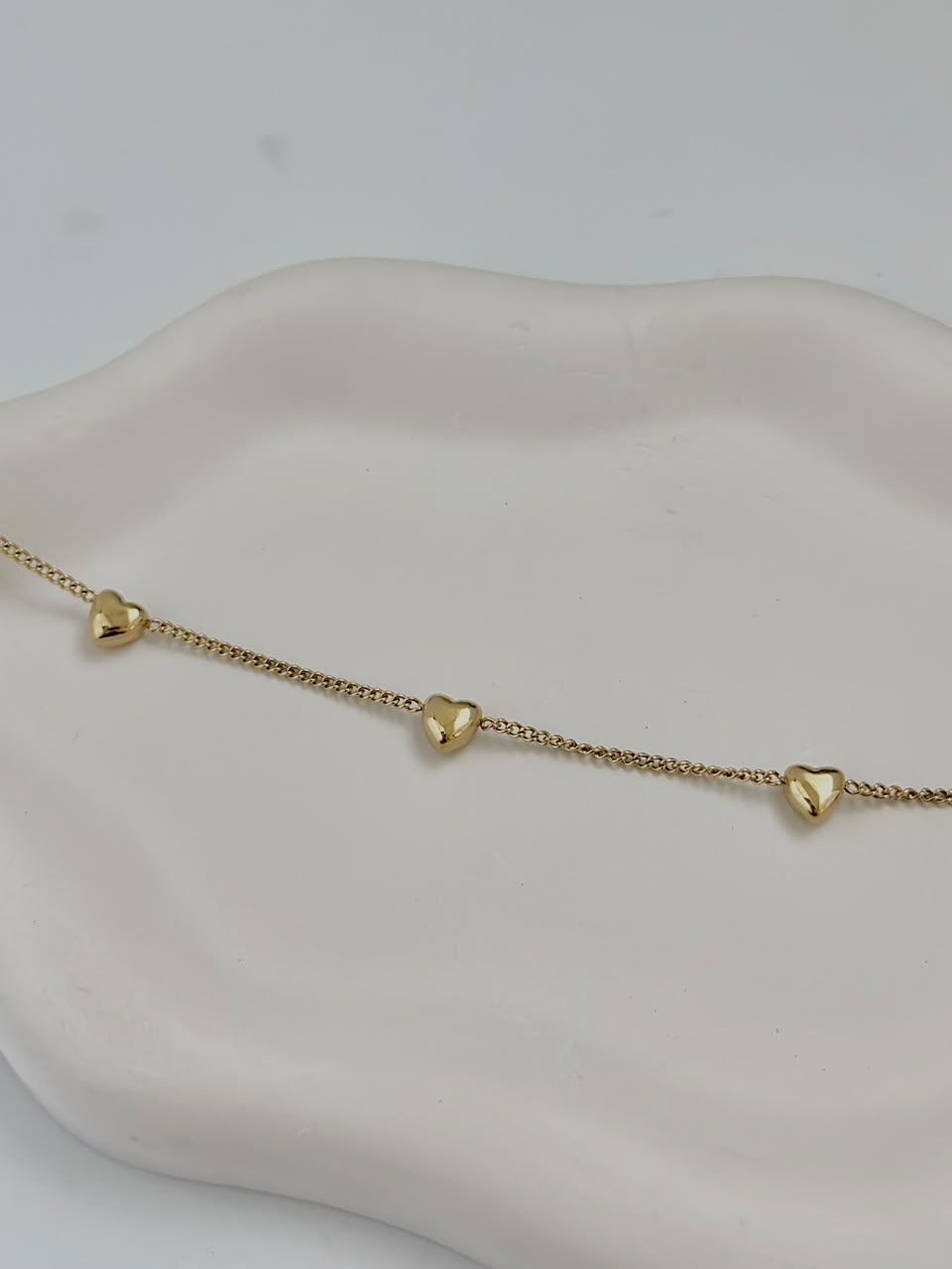 Bloslily multi-heart dainty charm bracelet featuring small heart-shaped charms on a delicate jewelry chain.