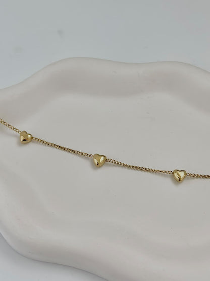 Bloslily multi-heart dainty charm bracelet featuring small heart-shaped charms on a delicate jewelry chain.
