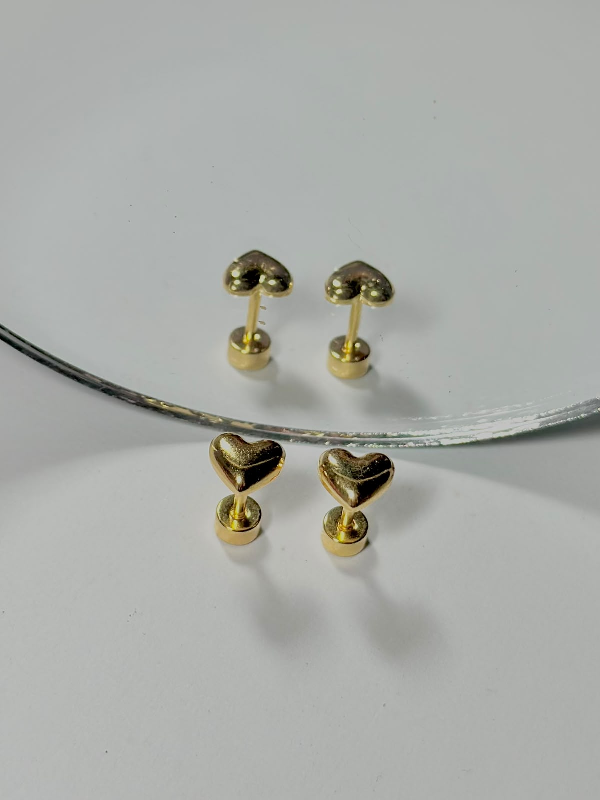 Bloslily Puffy Heart Screw-Back Stud Earrings in silver with a raised heart design, perfect for elegant jewelry styling.