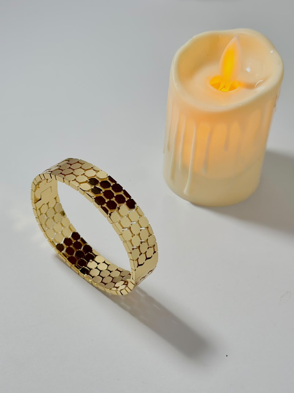 Silver honeycomb-shaped jewelry handcuff bracelet by Bloslily with intricate honeycomb detailing.
