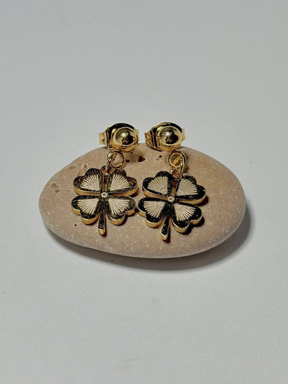 Bloslily textured four-leaf clover drop earrings with detailed leaf design, hanging from hooks in a jewelry display.