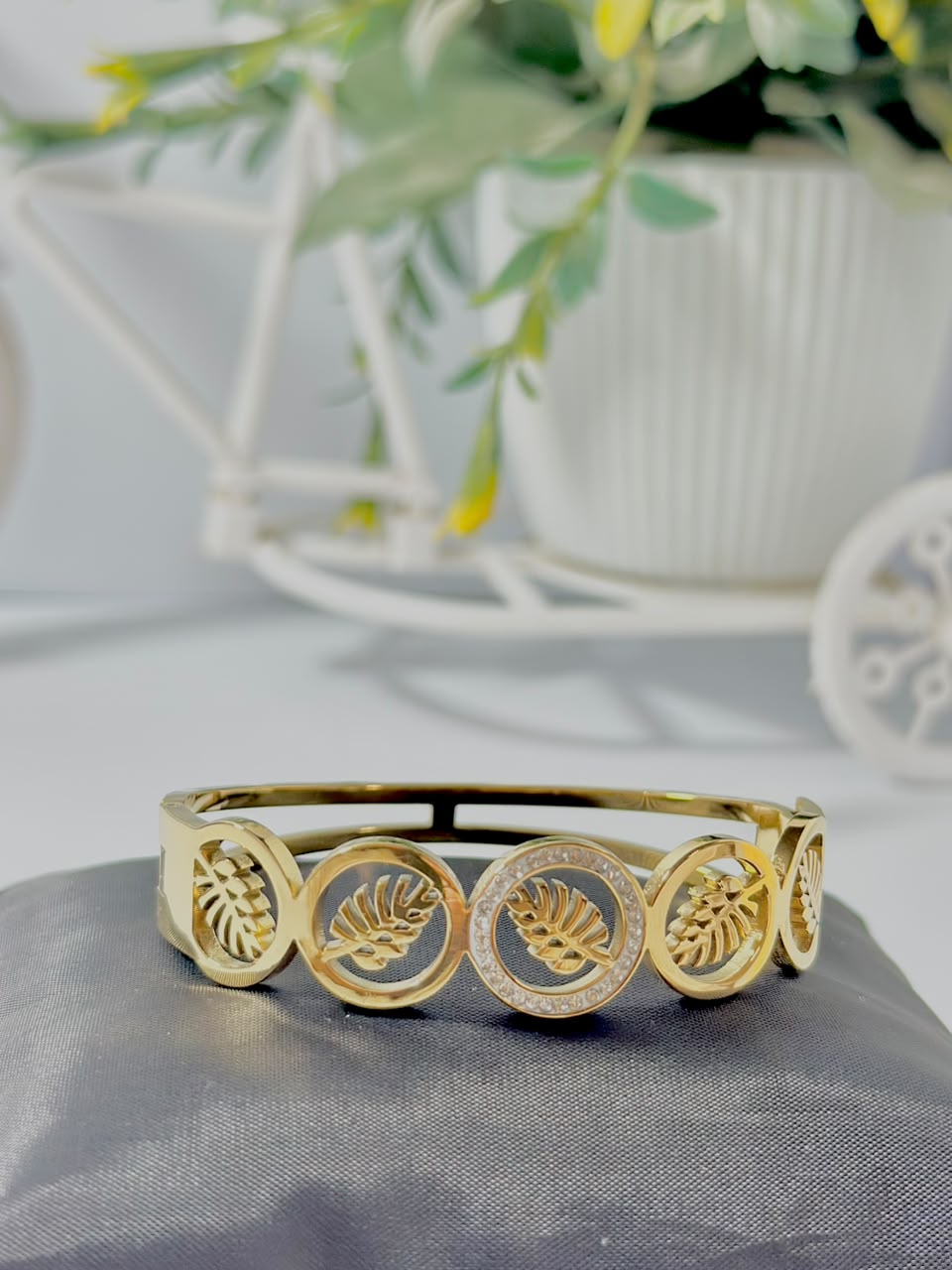 Bloslily Monstera leaf crystal handcuff jewelry featuring a detailed gold-tone leaf design with sparkling crystal accents.