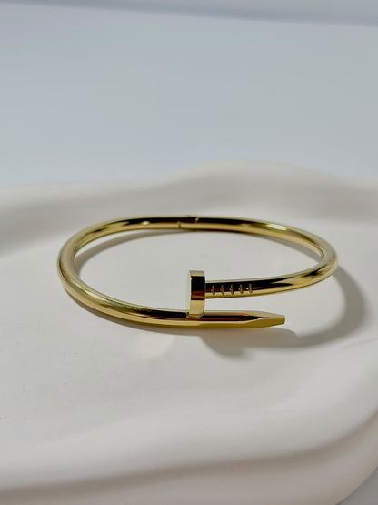 Silver nail-shaped handcuff jewelry by Bloslily, featuring intricate nail design and adjustable chain for a unique fashion statement.