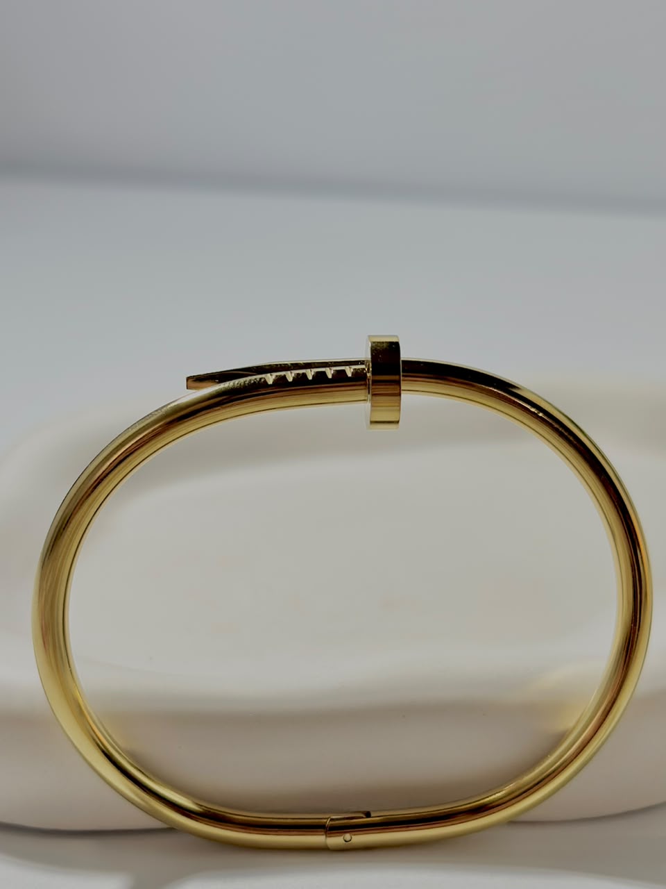 Silver nail-shaped handcuff jewelry by Bloslily, featuring intricate nail design with a sleek metallic finish.