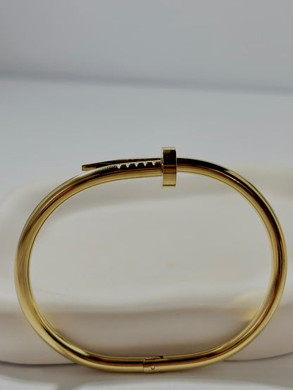 Silver nail-shaped handcuff jewelry by Bloslily, featuring intricate nail design with a sleek metallic finish.