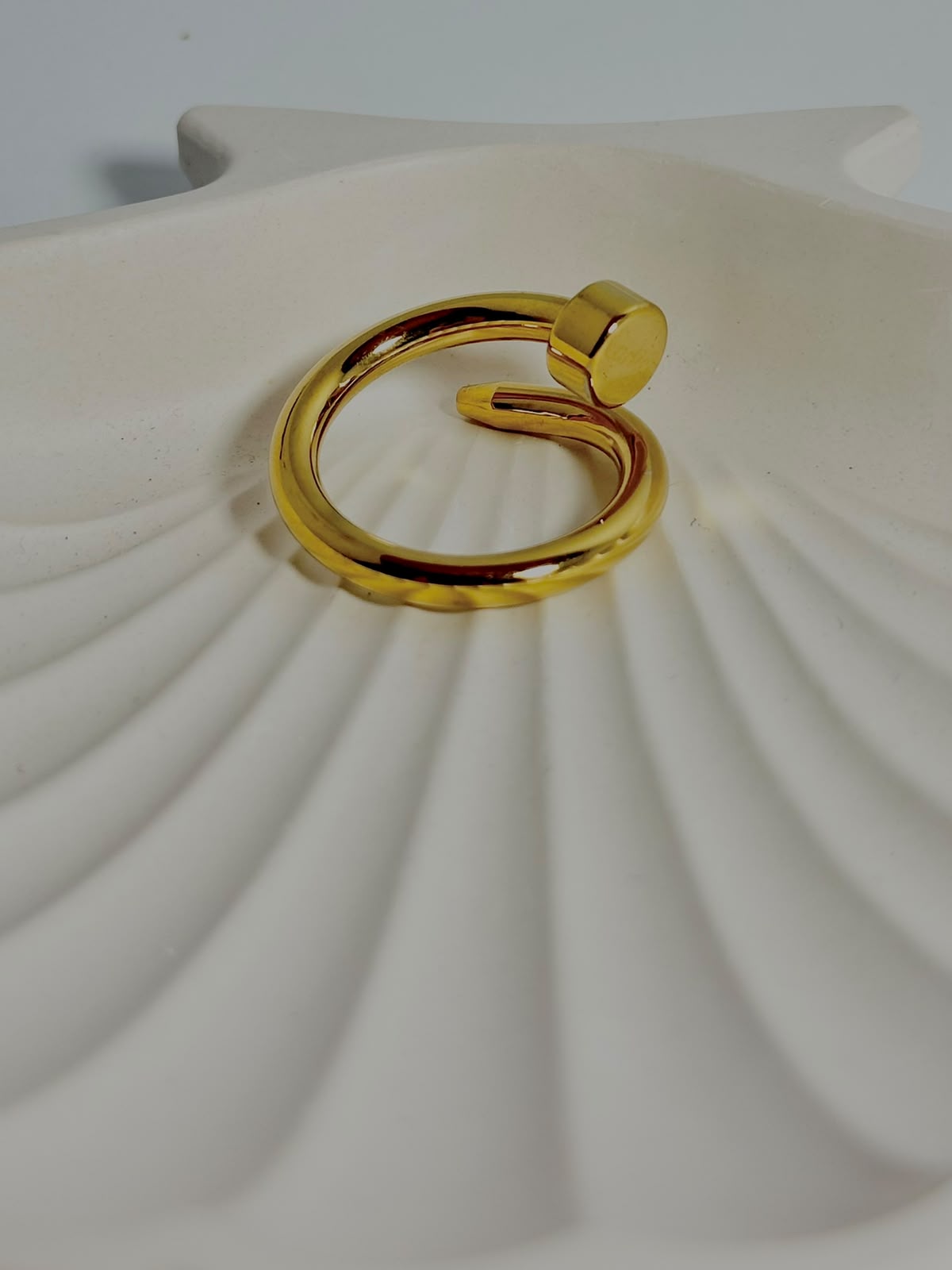 Silver nail ring jewelry by Bloslily featuring a sleek, modern design on a person's finger.