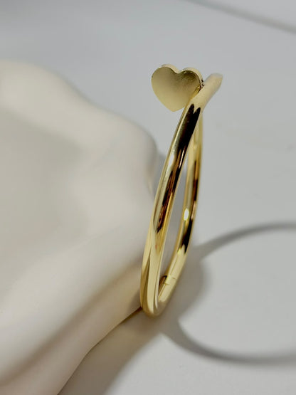 Silver Nail Heart Handcuff jewelry by Bloslily, featuring a unique nail-shaped heart design on a stylish bracelet.