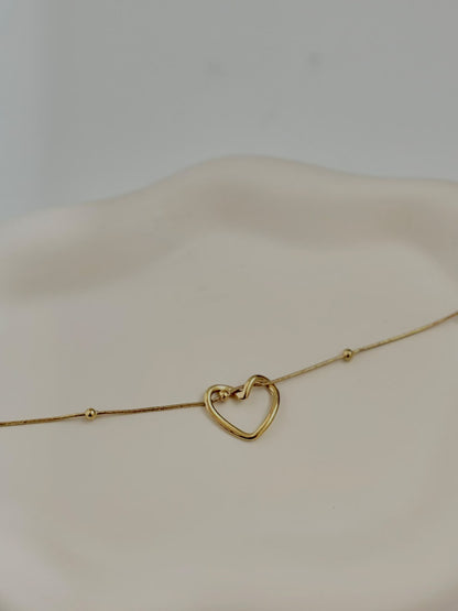 Silver intertwined heart bracelet from Bloslily featuring a delicate jewelry design with interconnected heart shapes.