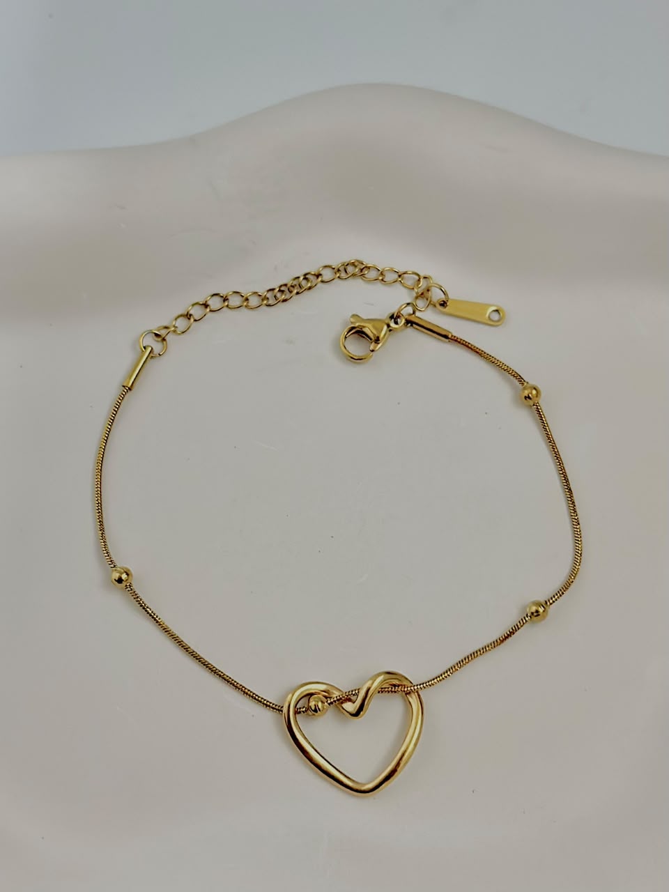Silver intertwined heart bracelet from Bloslily jewelry featuring delicate heart outlines and intricate design.