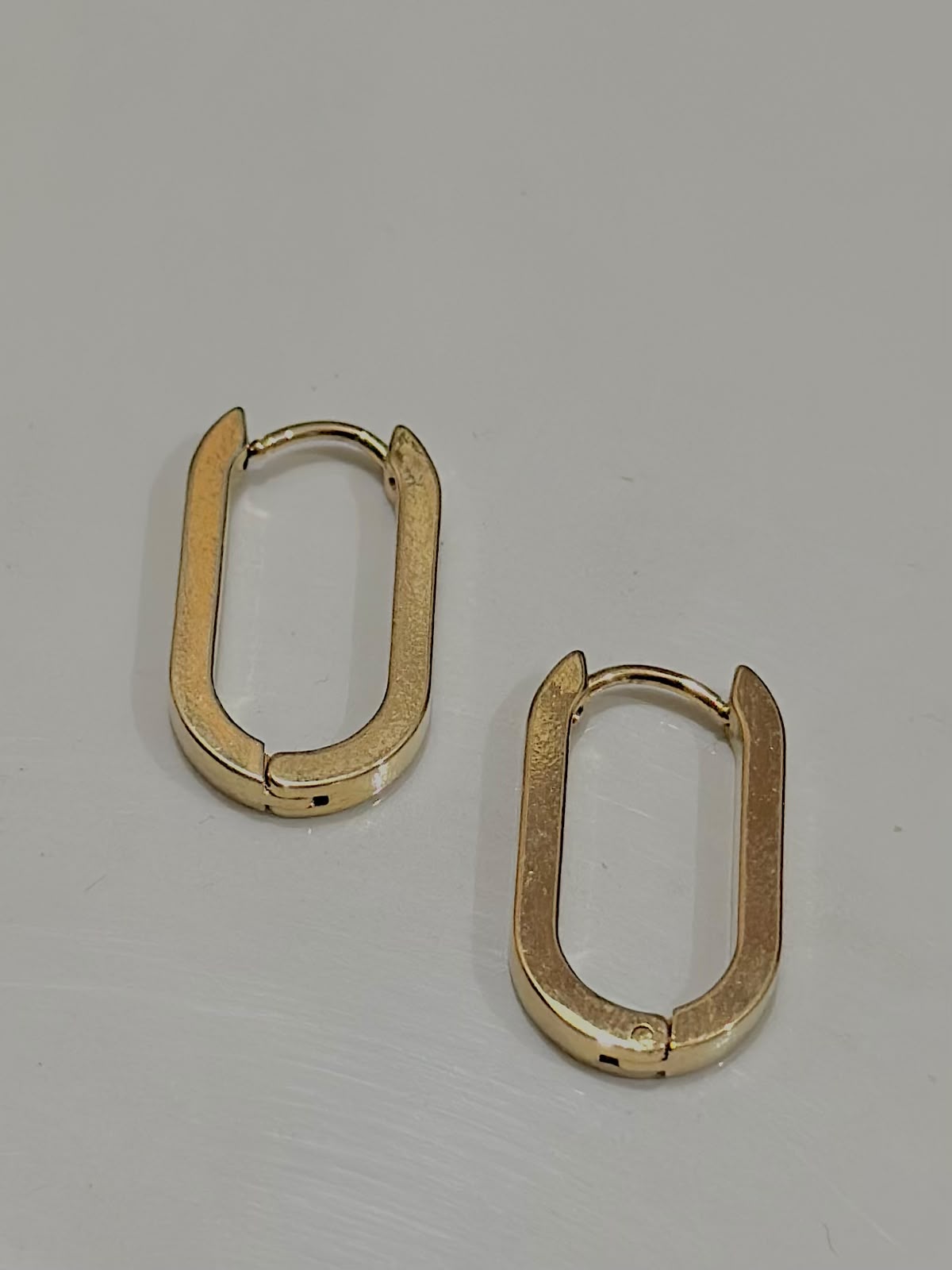 Bloslily U-shape geometric earrings with oval design, showcasing modern jewelry with sleek, minimalist style.