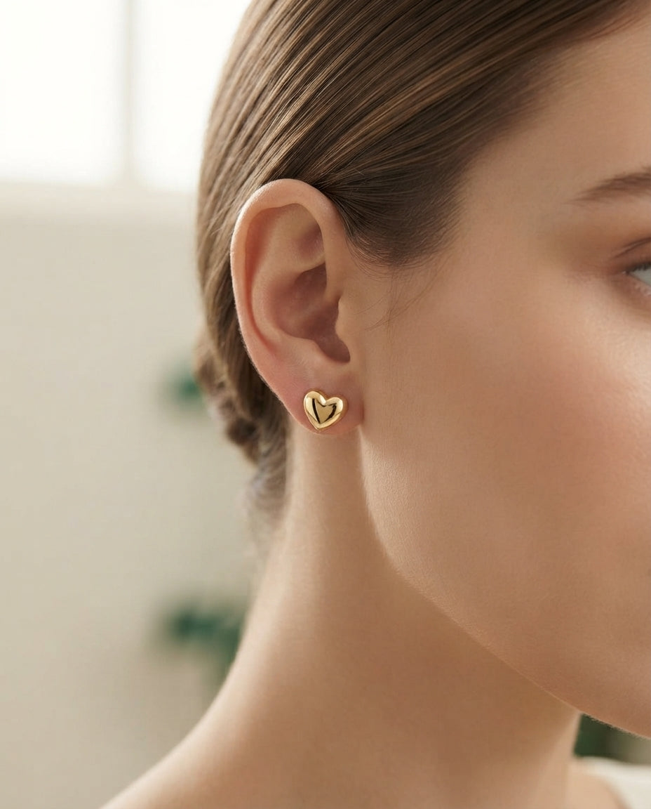 Bloslily puffy heart screw-back stud earrings with a shiny, rounded heart design in silver tone, suitable for everyday wear.