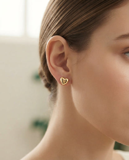 Bloslily puffy heart screw-back stud earrings with a shiny, rounded heart design in silver tone, suitable for everyday wear.